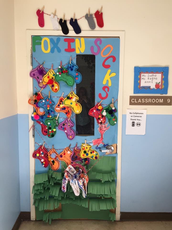 Classroom door decorated with colorful sock cutouts and the words "FOX IN SOCKS"