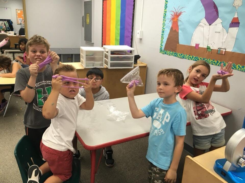 Children playing with slime in a classroom