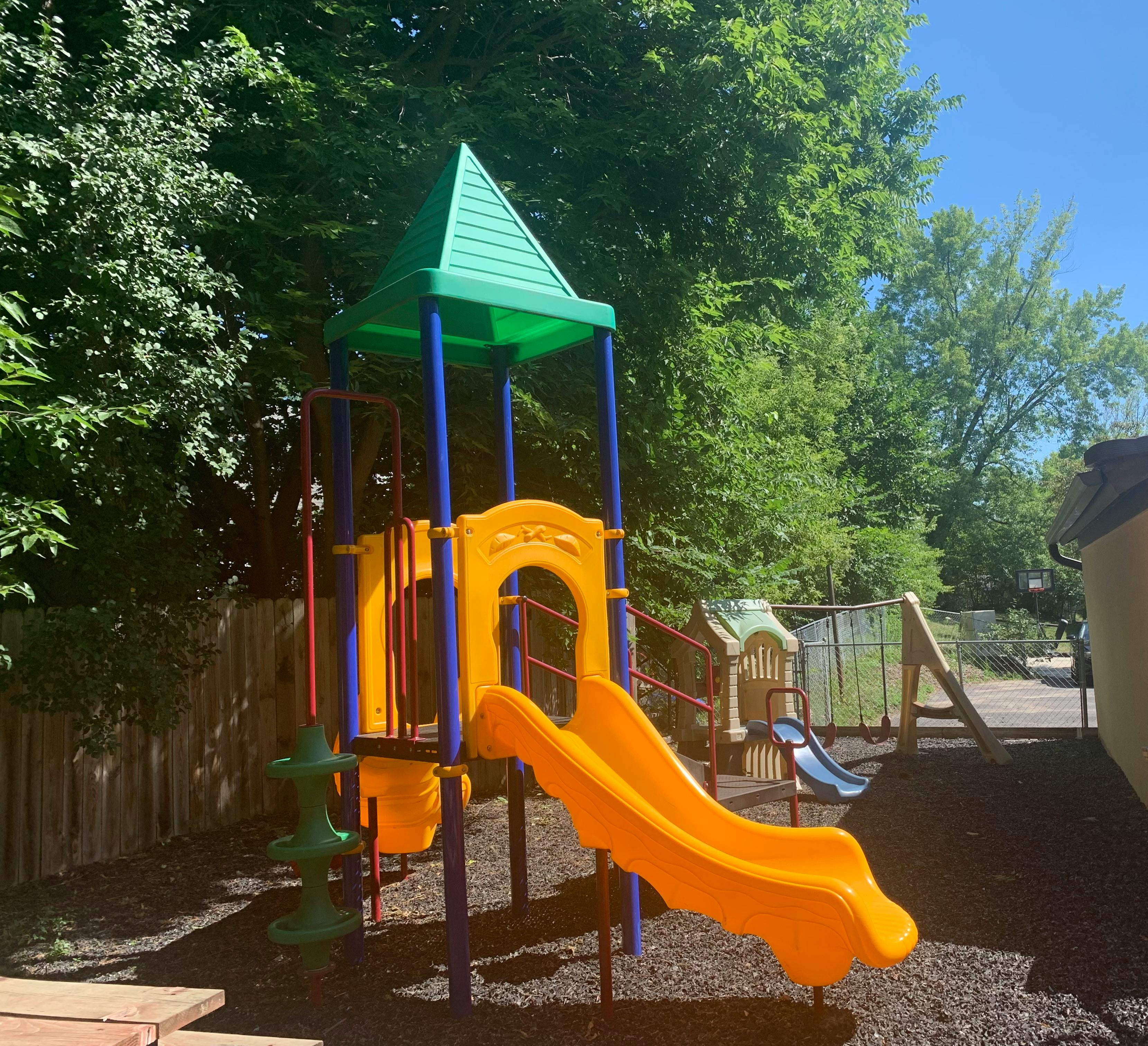 Playground structure with a slide in a backyard
