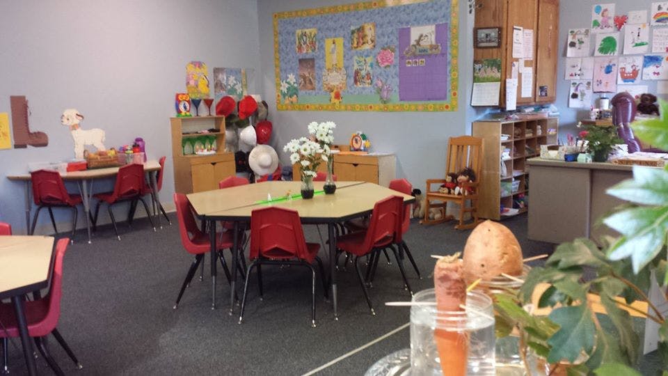 Classroom with small tables and red chairs