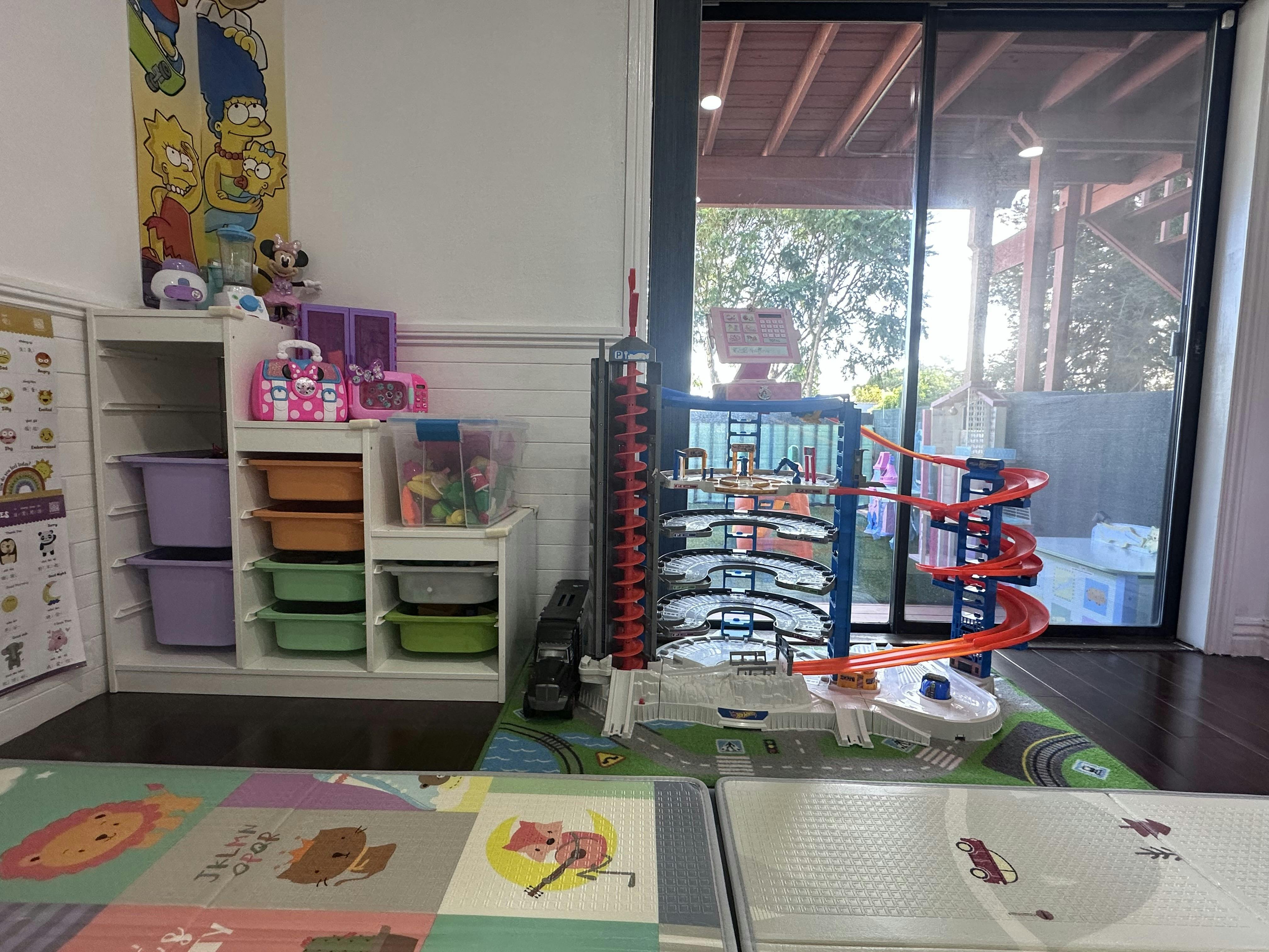 Play area with toy storage unit and a multi-level toy parking garage