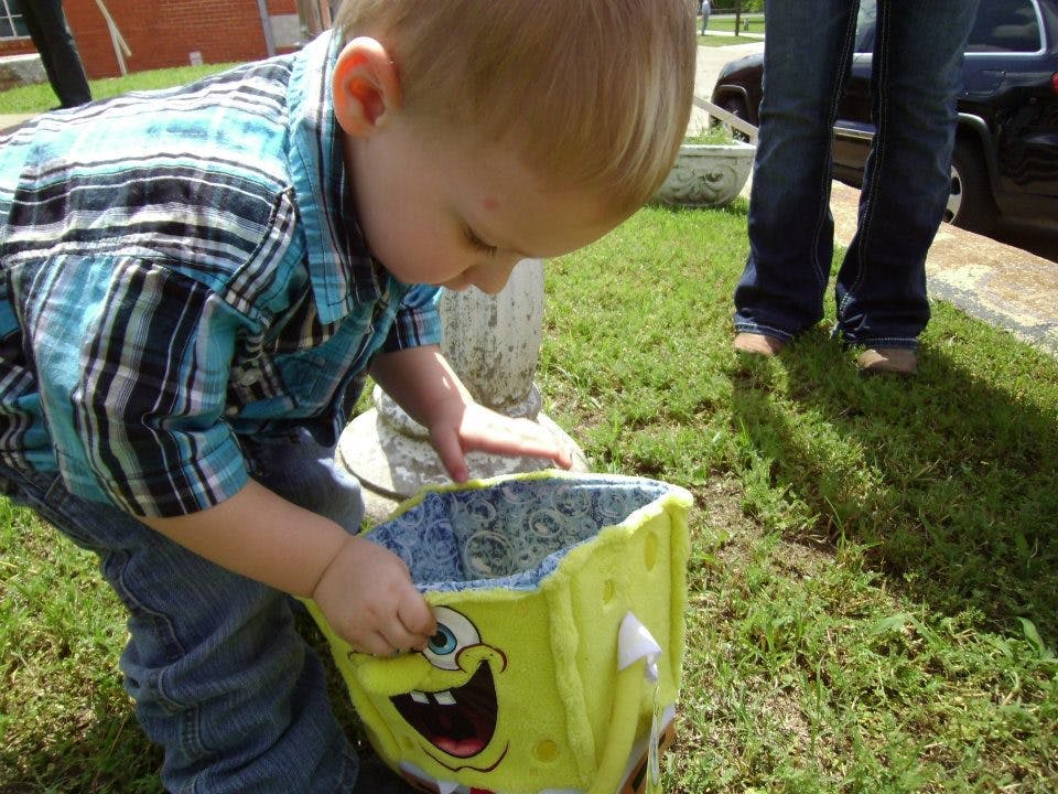 Child looking into a yellow Spongebob Squarepants basket