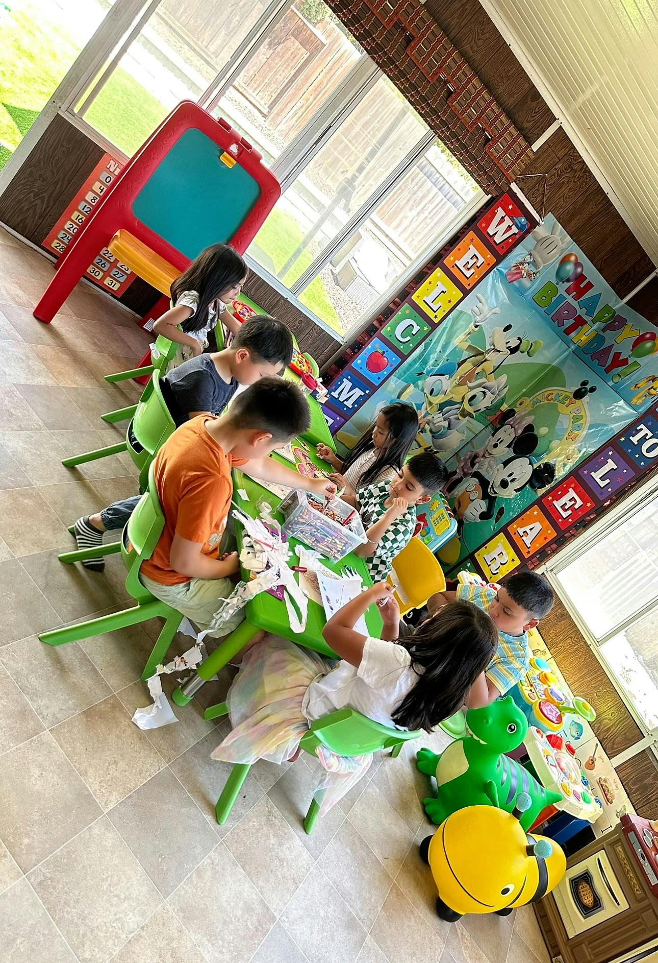 Children sitting at tables in a classroom