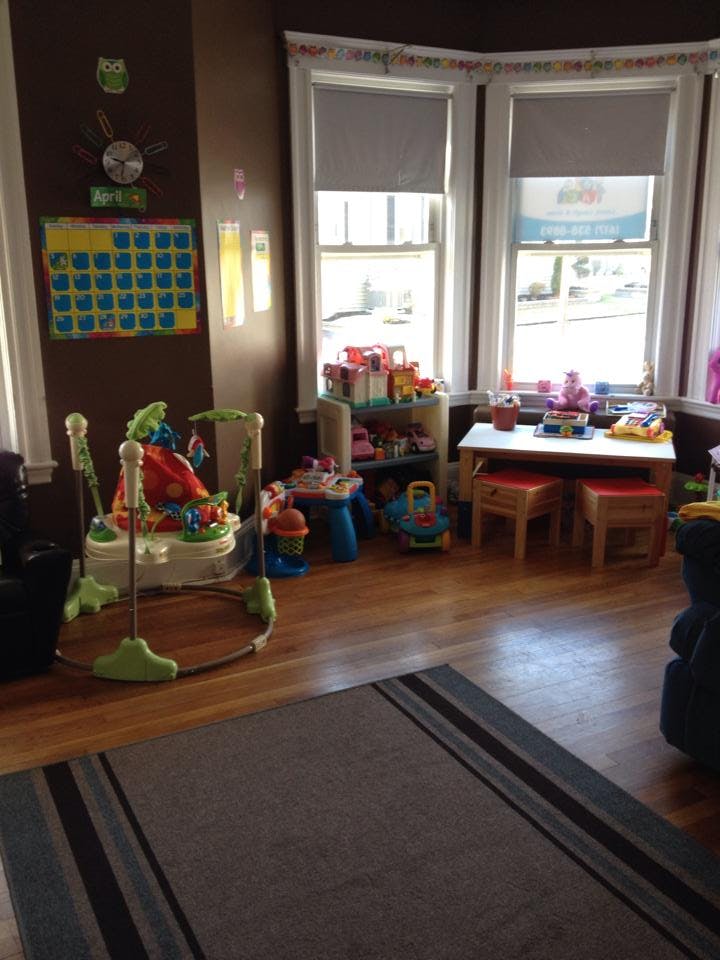 Playroom with baby bouncer, toys, and small table with chairs