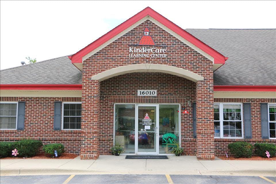 Brick building with a red roof and the words "KinderCare Learning Center" on the facade