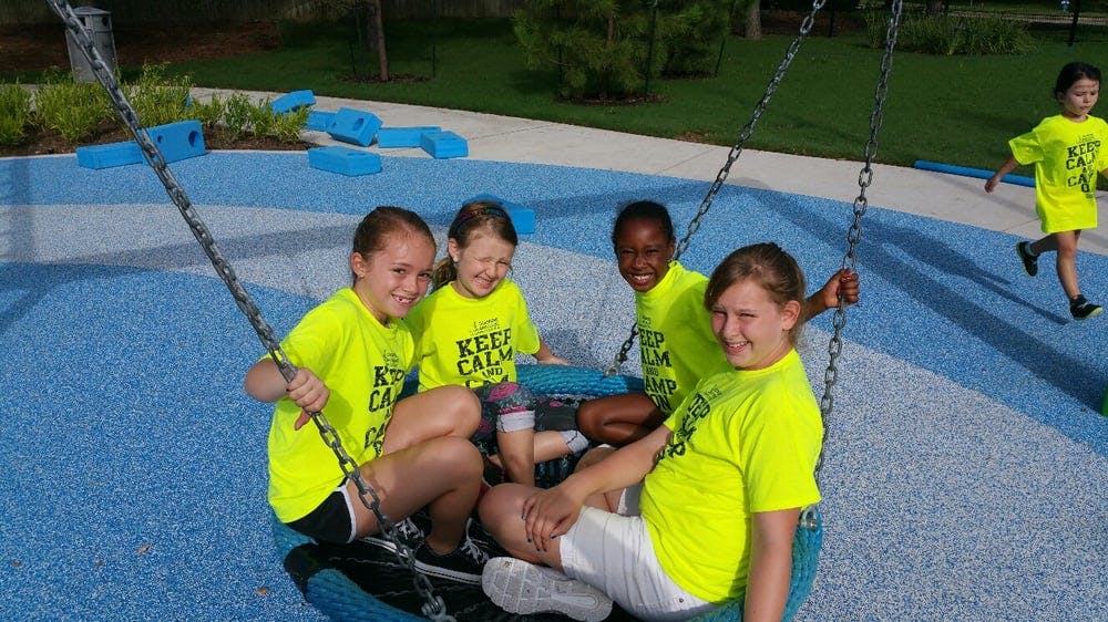 Four children in a swing on a playground