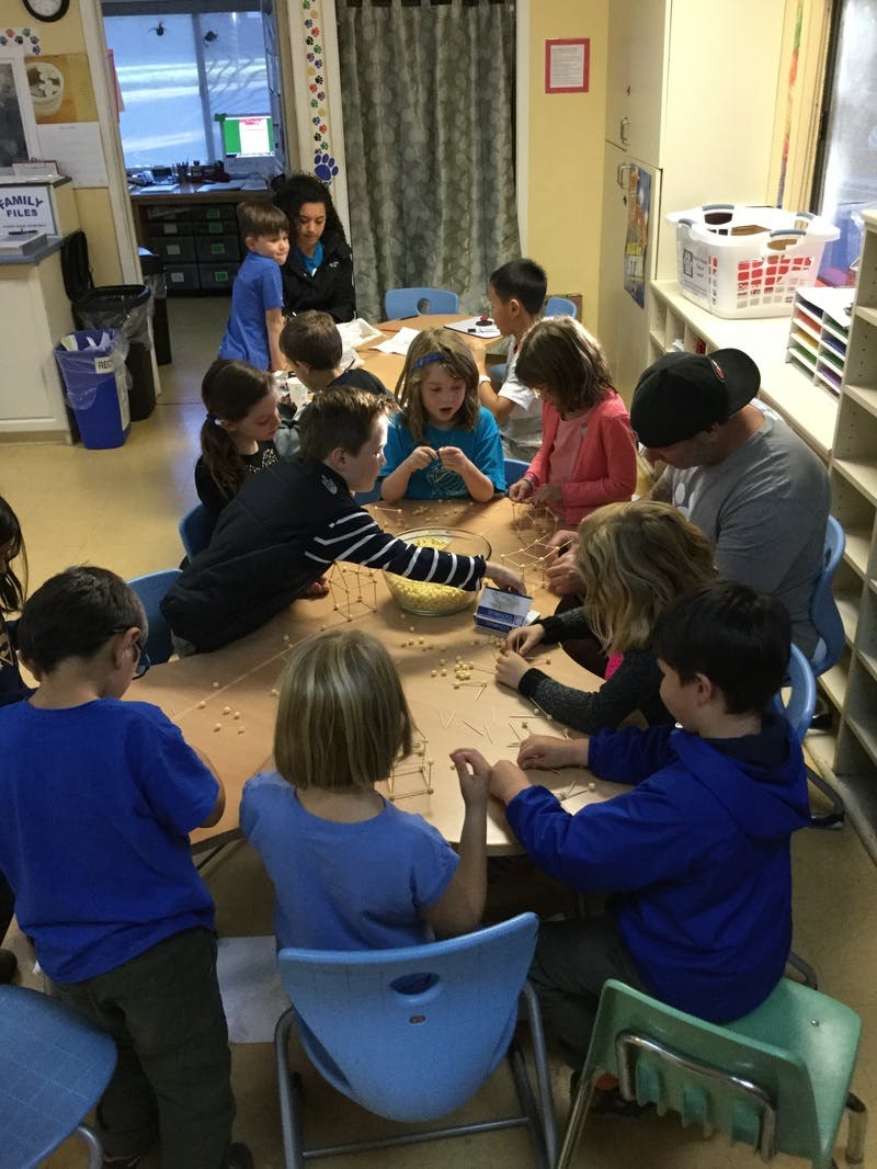 Children and adults gathered around a table