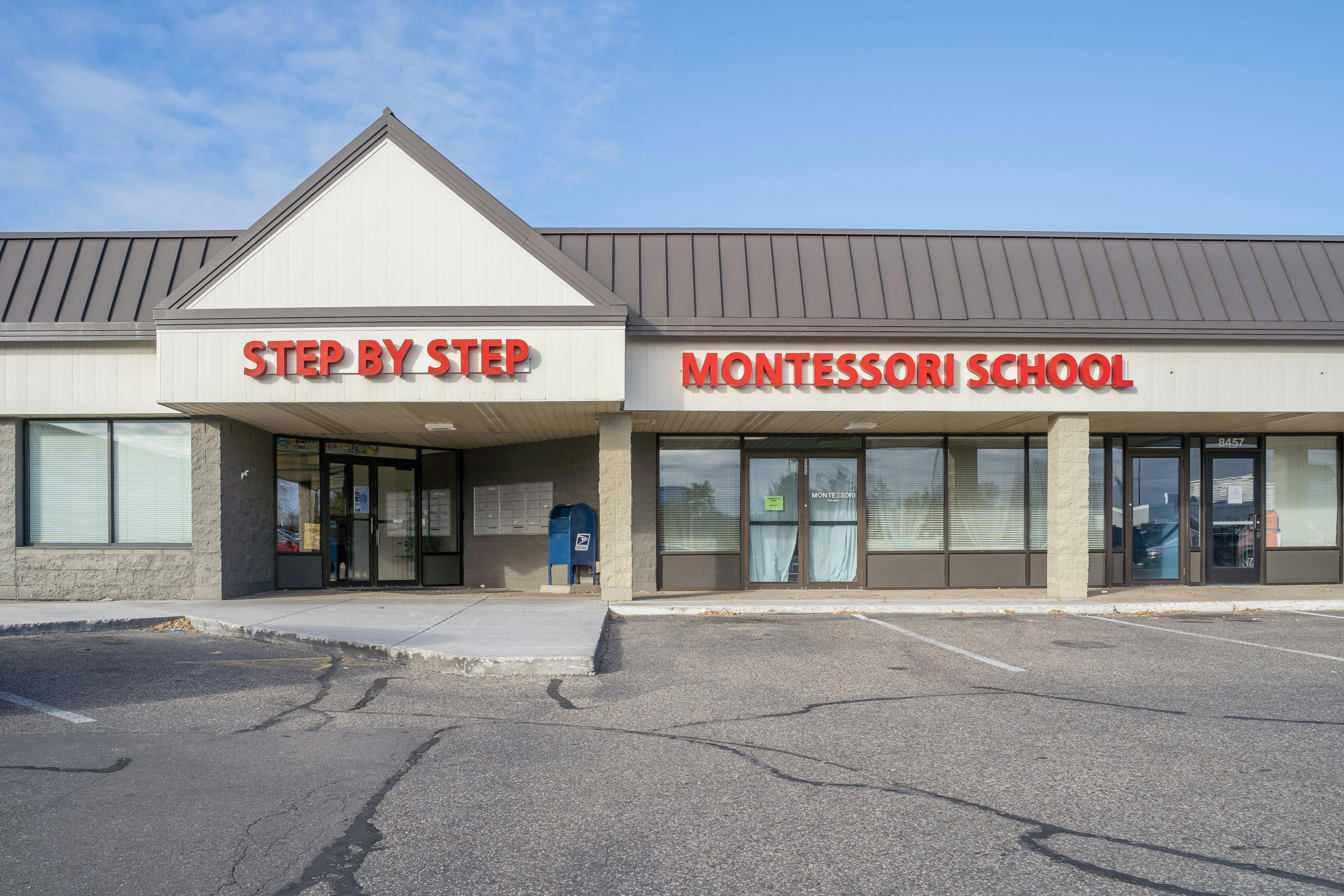 Building with "Step by Step" and "Montessori School" signs
