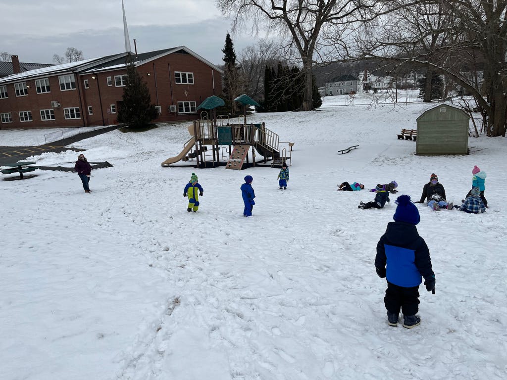 Children playing in the snow on a playground