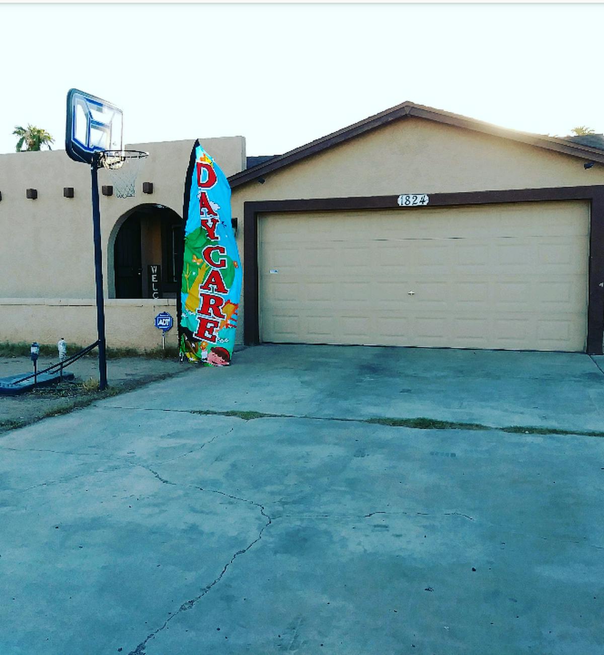 Daycare sign in front of a house with a basketball hoop