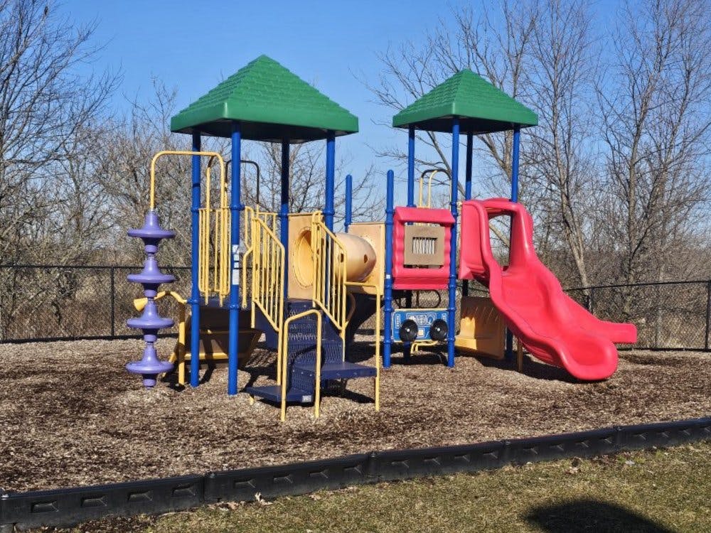 Colorful playground structure with slides, tunnels, and climbing elements