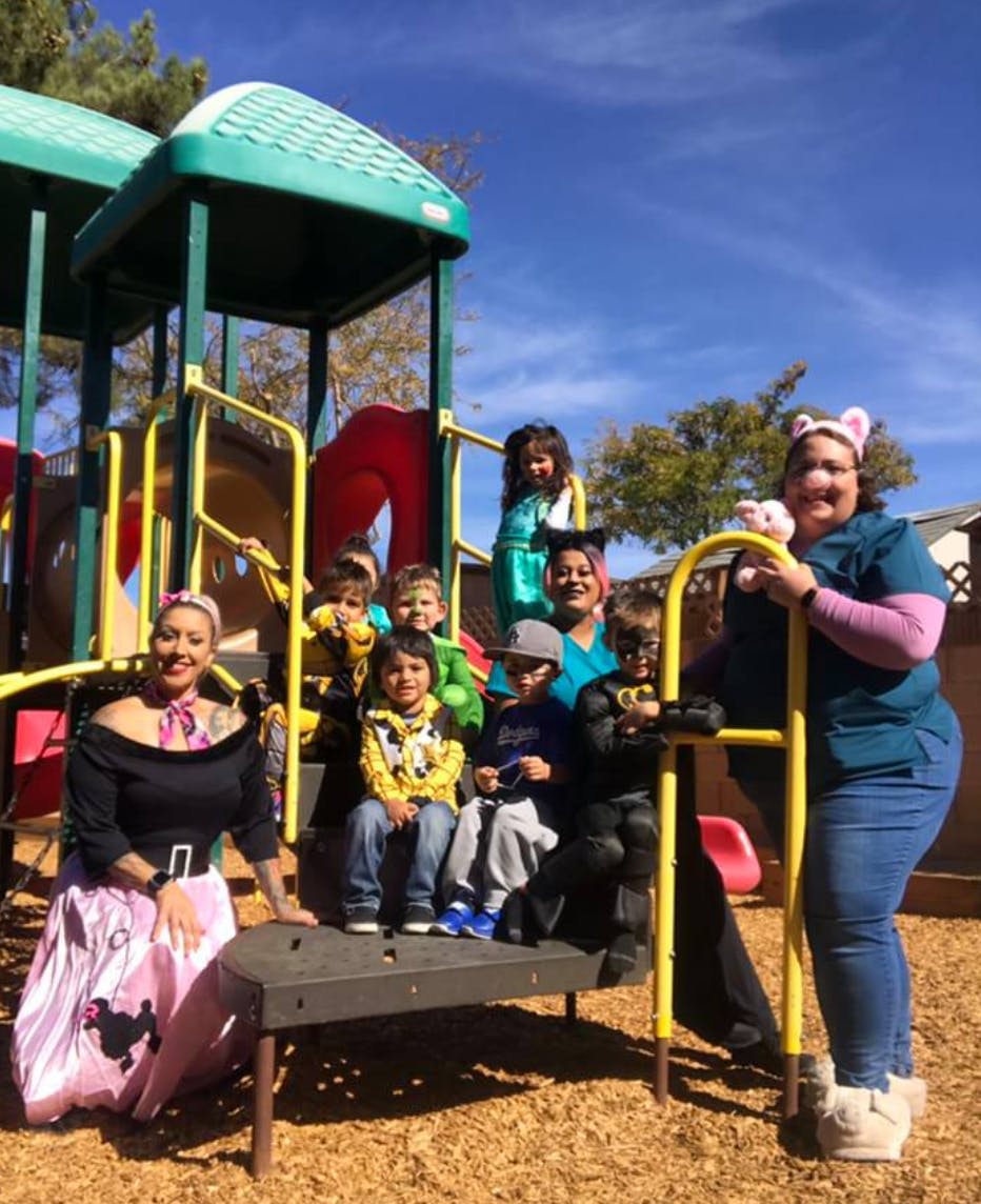 Adults and children posing on a playground