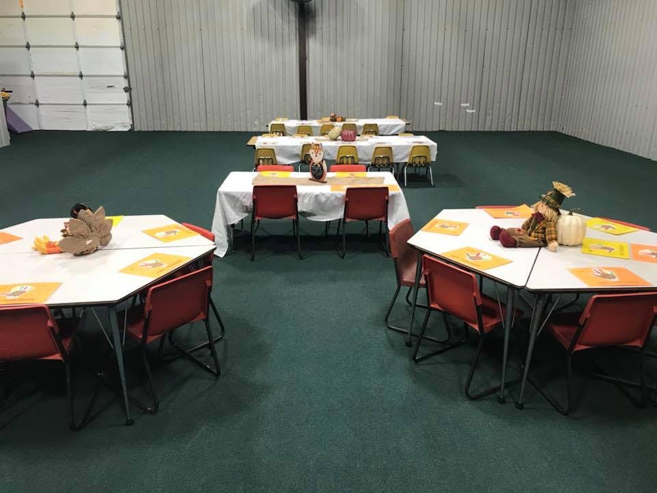 Tables with chairs set up in a large room