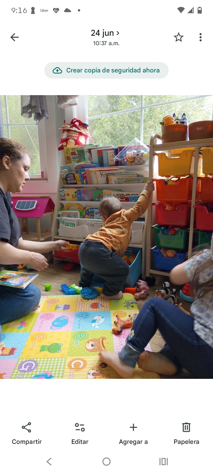 People playing with toys on a mat in a room
