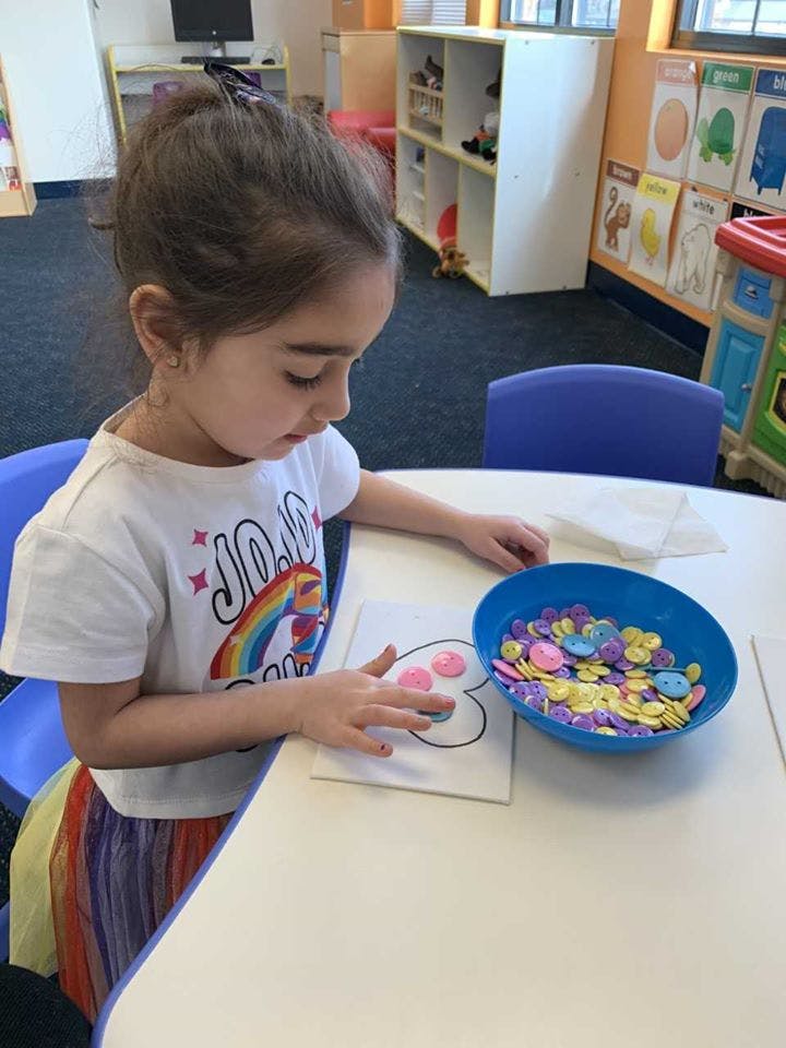 Child doing an art activity at a table
