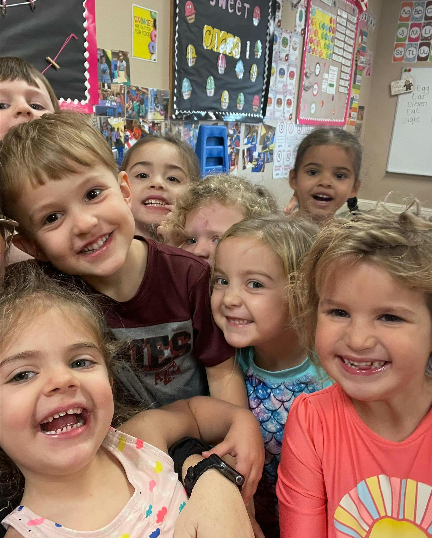 Group of children smiling and looking at the camera