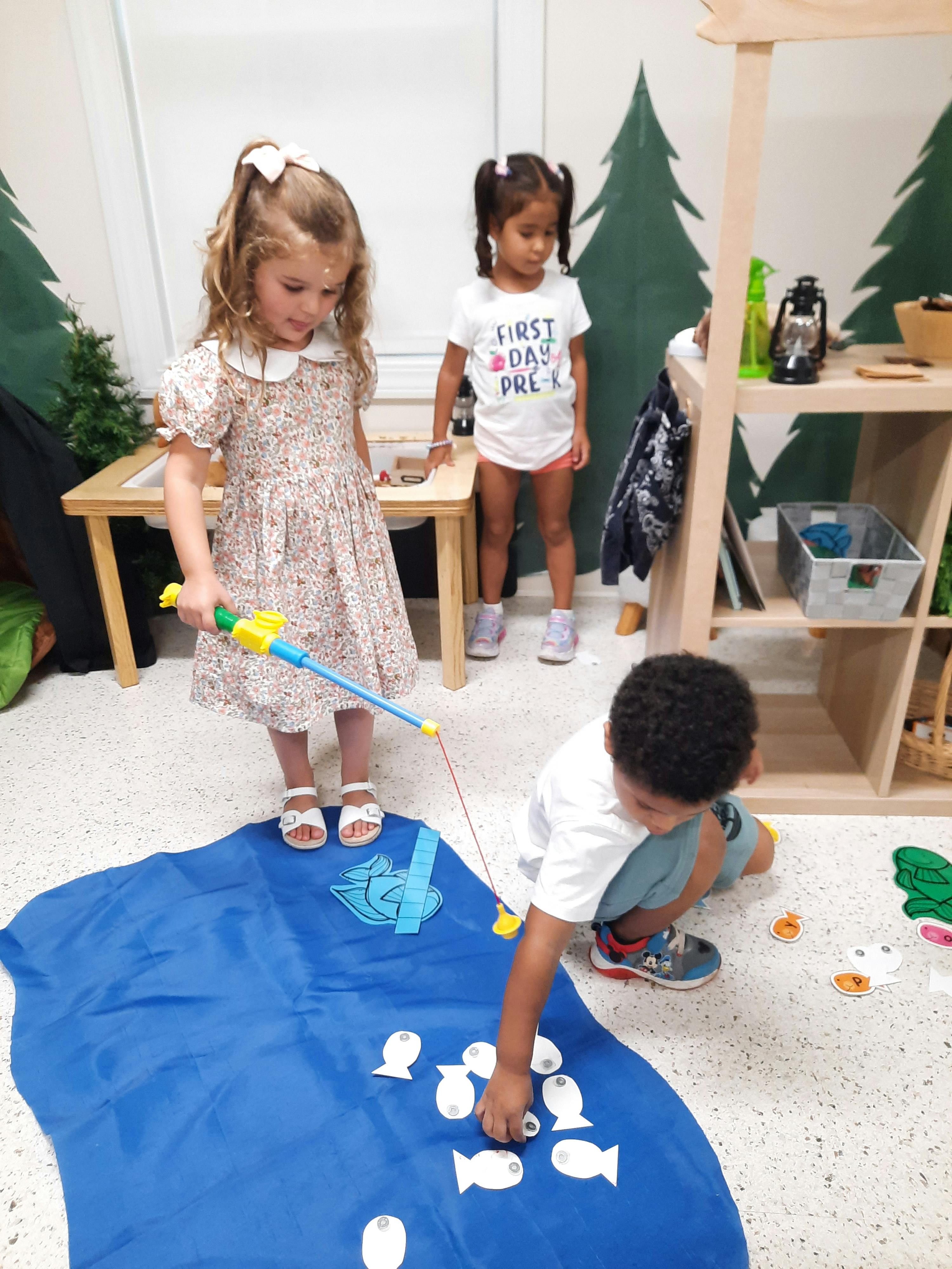 Children playing with a magnetic fishing game in a classroom