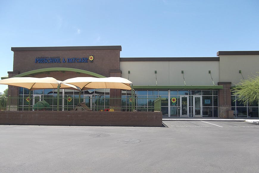 Storefront with outdoor seating under umbrellas