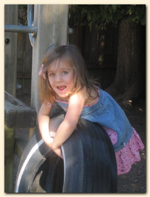 Child on a tire swing