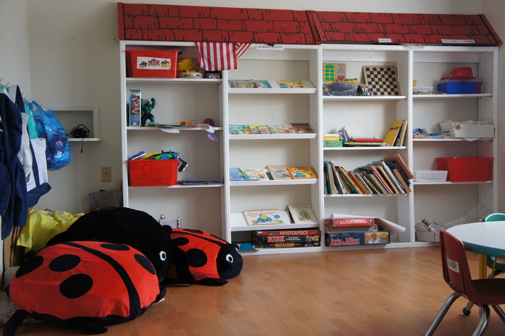 Ladybug floor cushions in a classroom with bookshelves