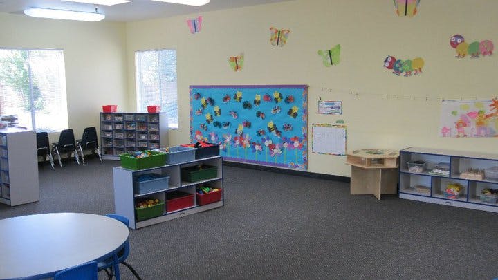Empty classroom with bulletin board and shelves