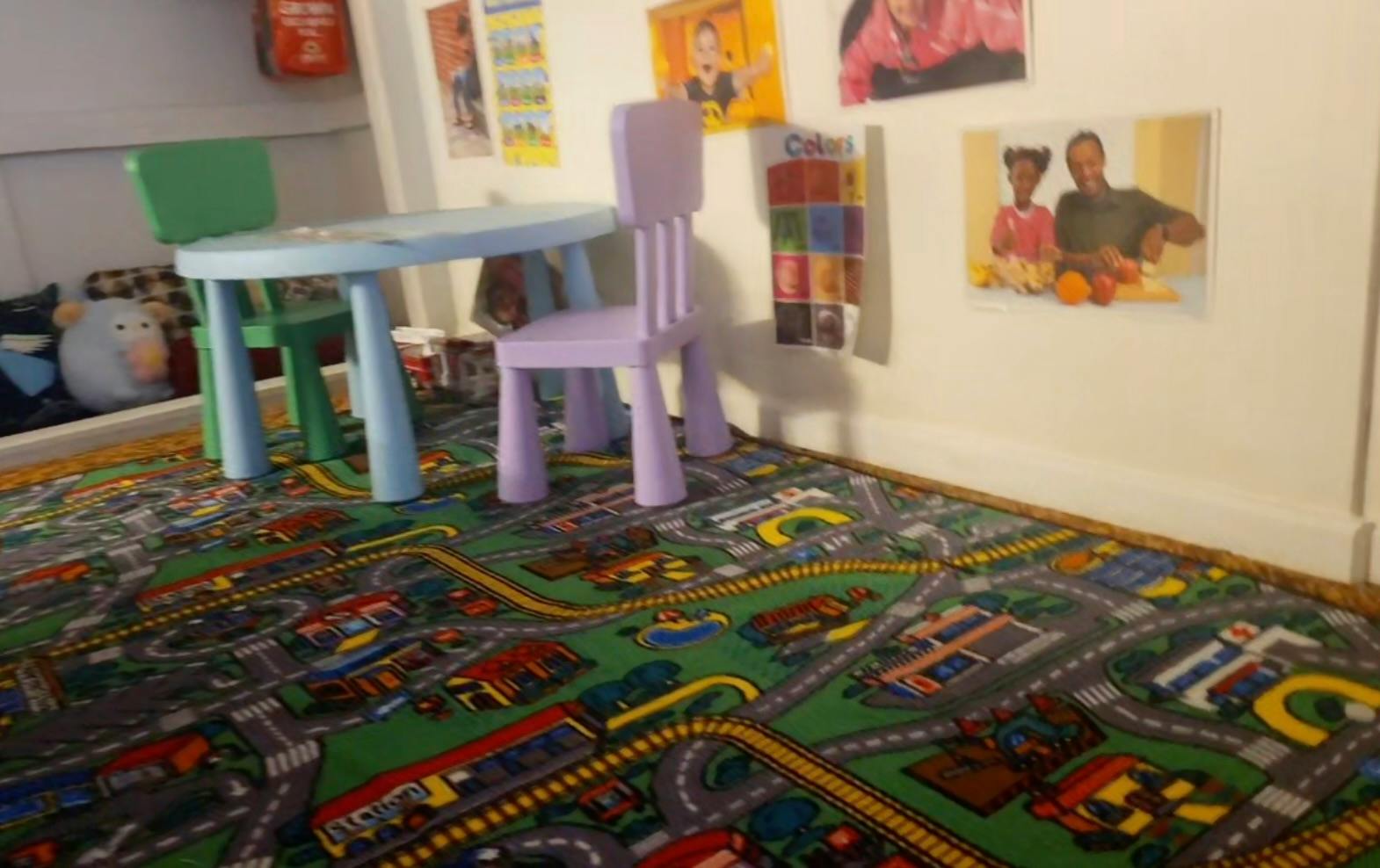 Small table and chairs on a city-themed play rug