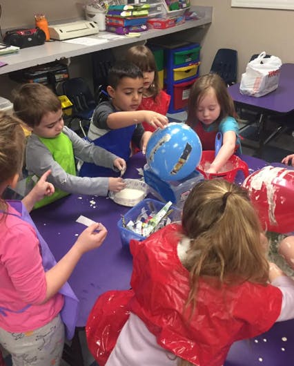 Children doing a craft project at a table