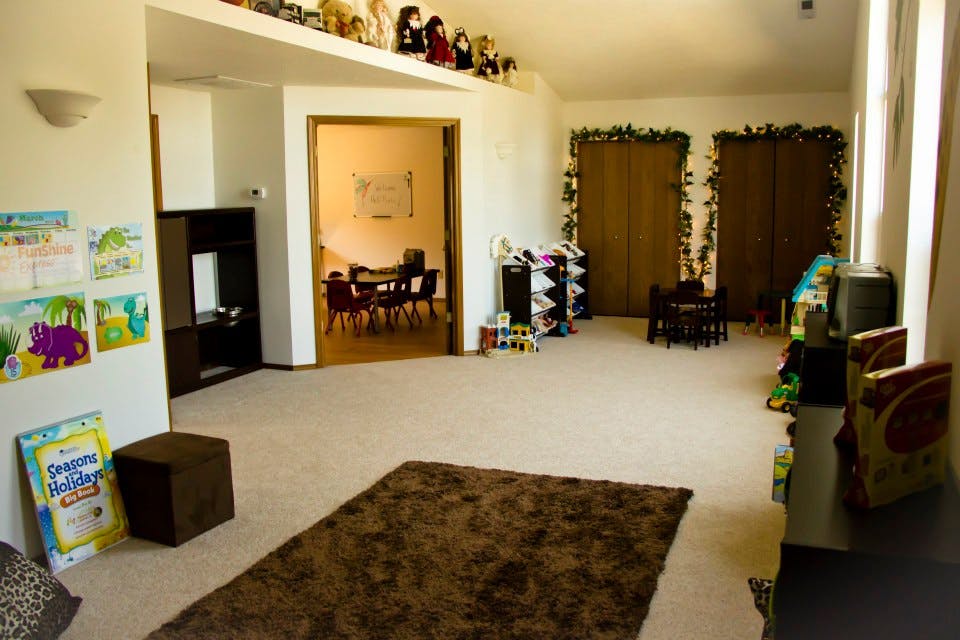 Empty room with a brown rug on the carpeted floor