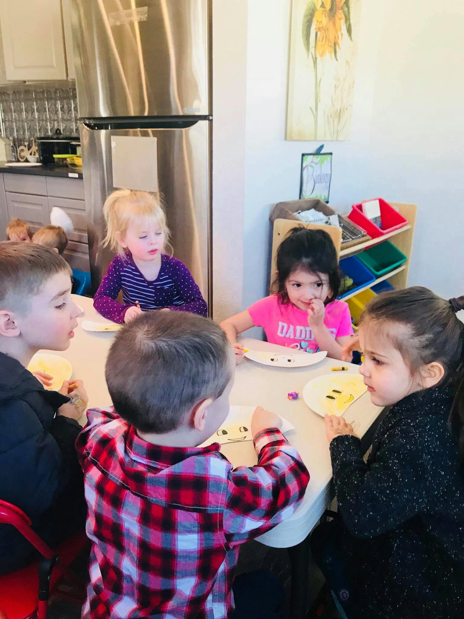 Children sitting around a table with plates