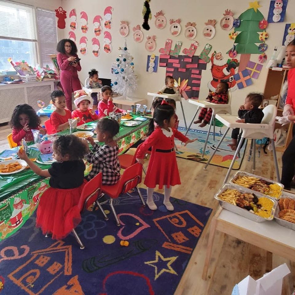 Children and adults in a room with holiday decorations