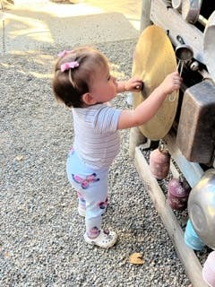 Child playing with a cymbal