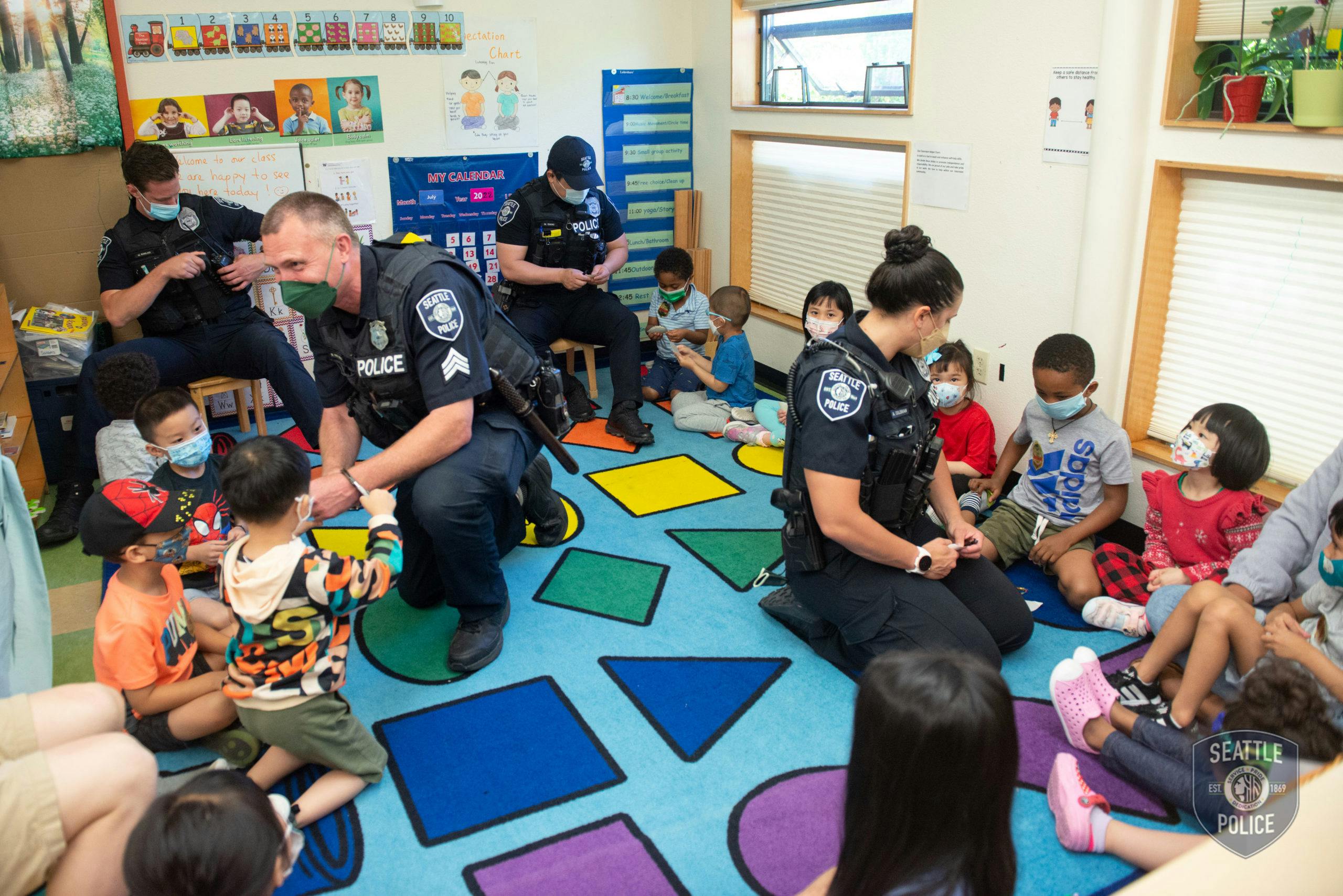 Police officers in uniform interacting with children in a classroom