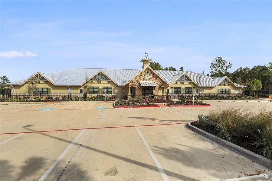 Exterior view of a building with a parking lot in front