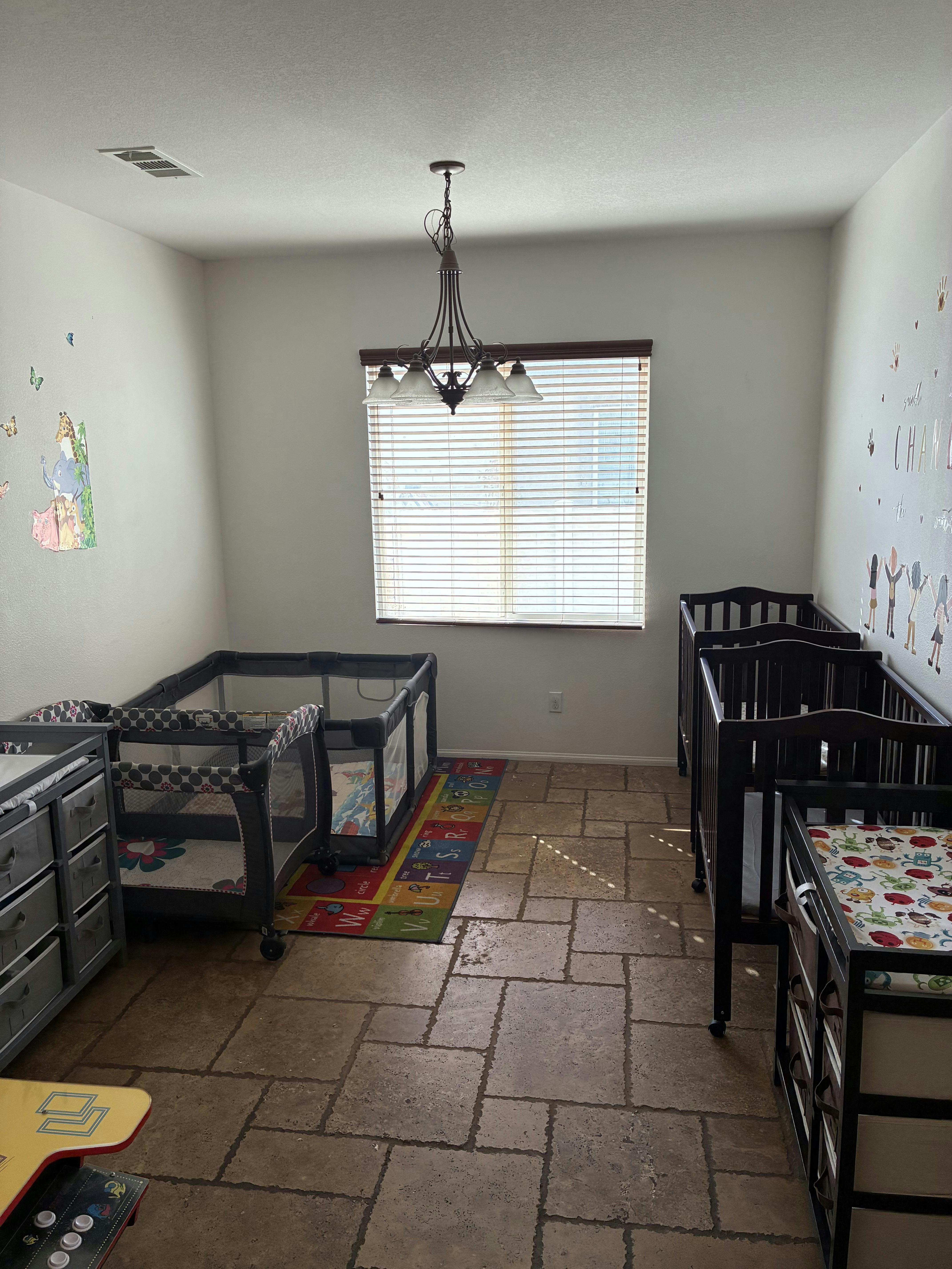 Room with multiple cribs and playpens