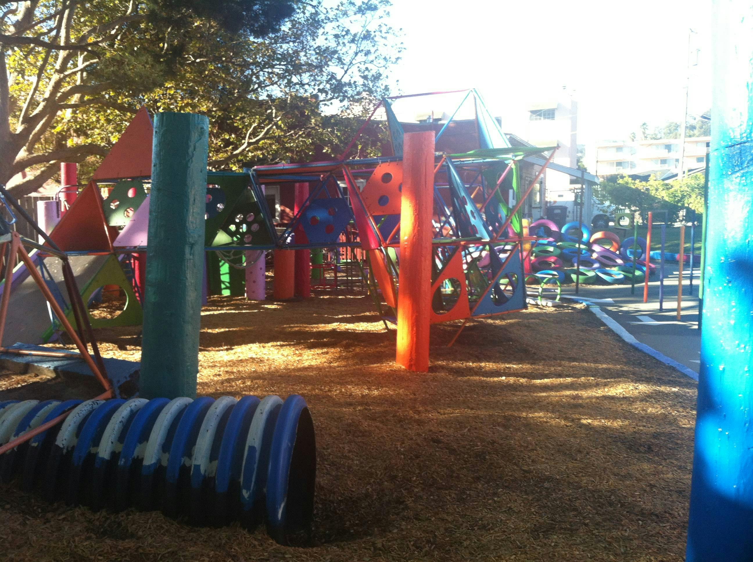 Playground with colorful climbing structures and a blue tunnel