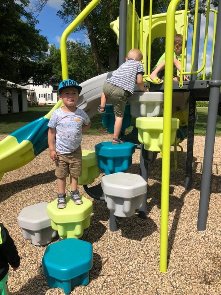 Children playing on a playground climbing structure