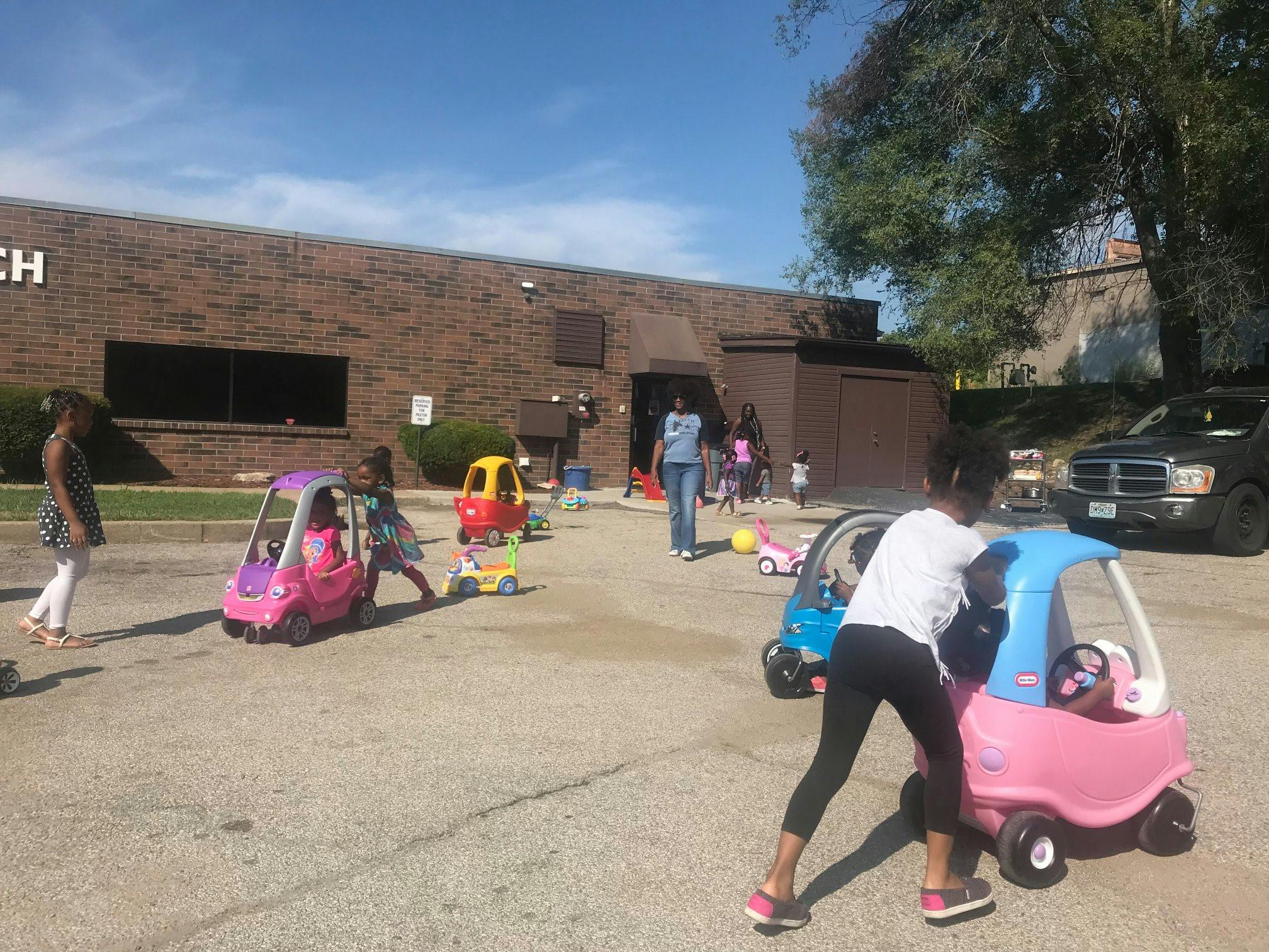 Children playing with toy cars outdoors