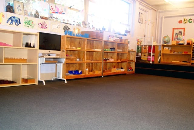 Classroom with shelves of learning materials and a computer