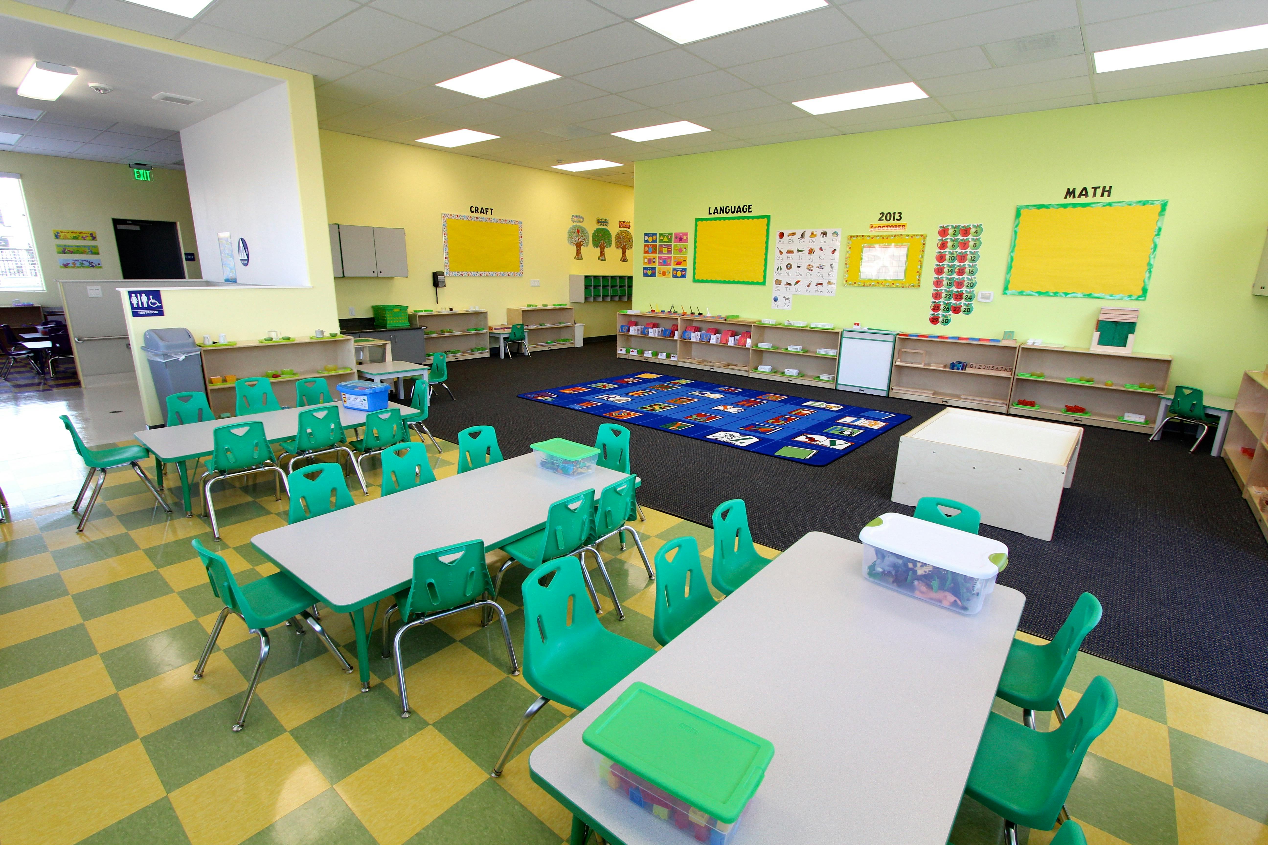 Empty classroom with small tables and chairs