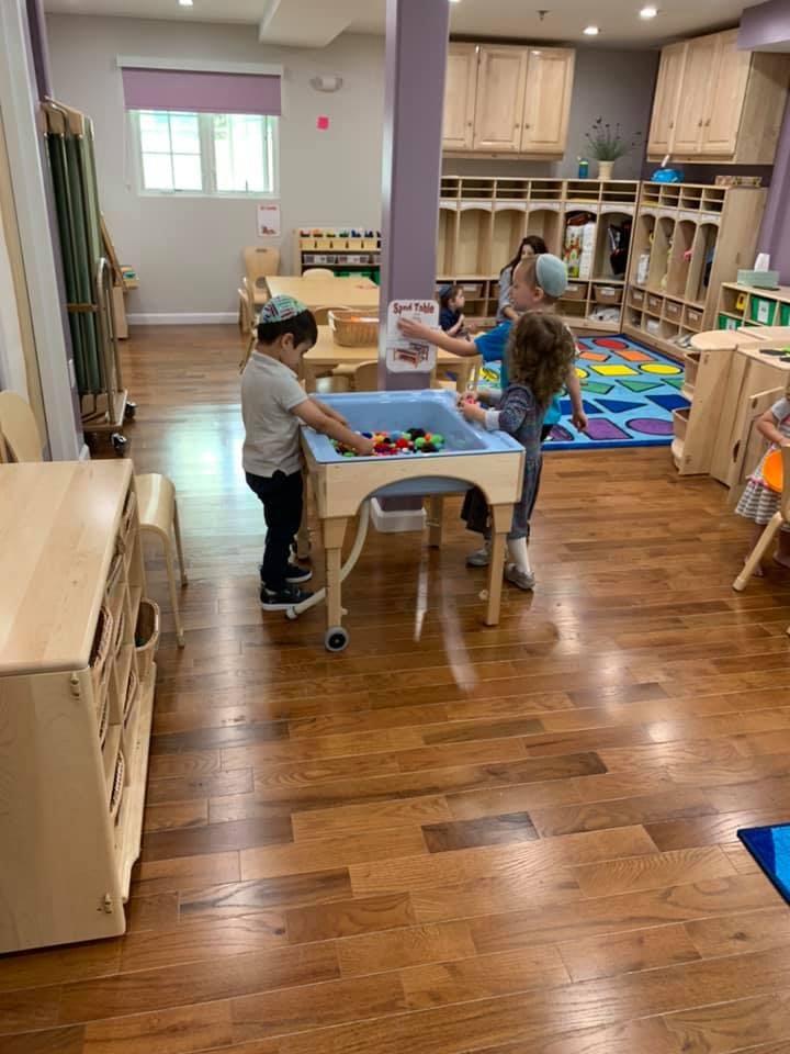 Children playing with toys in a classroom