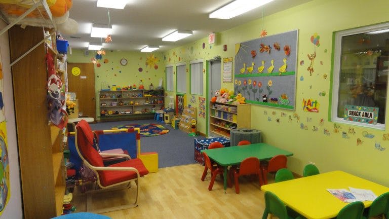 Empty classroom with small tables and chairs