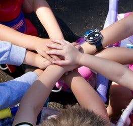 Multiple children's hands stacked together