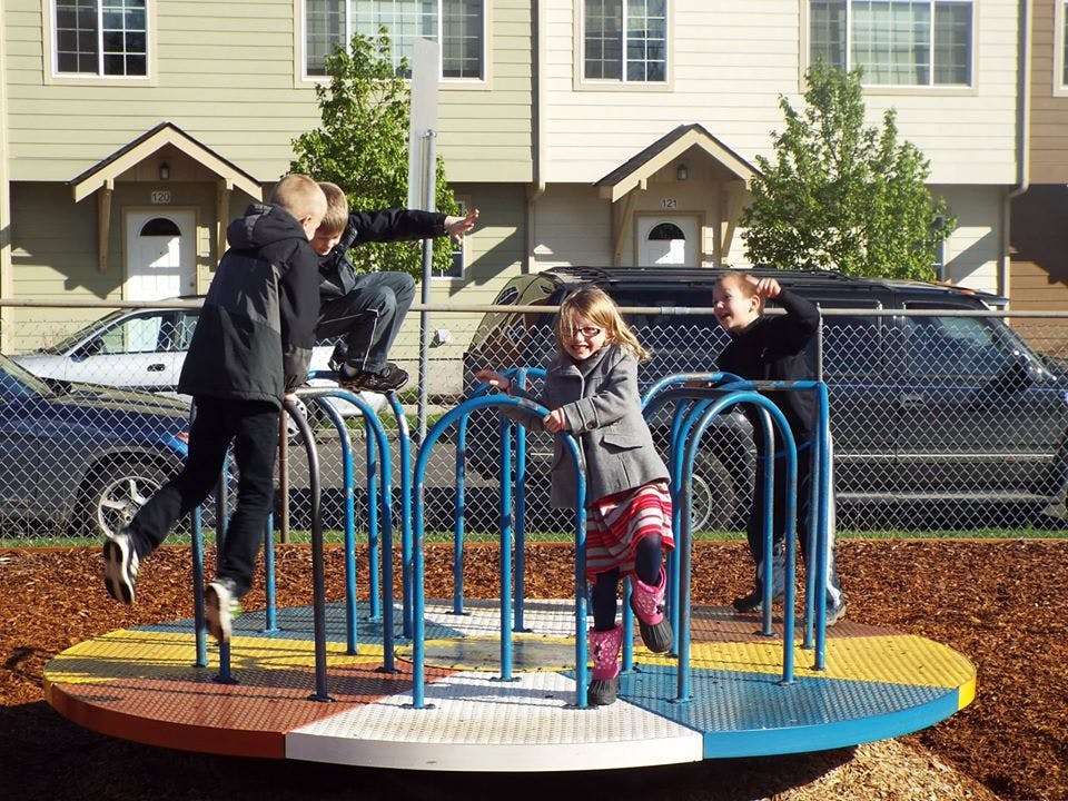 Children playing on a merry-go-round