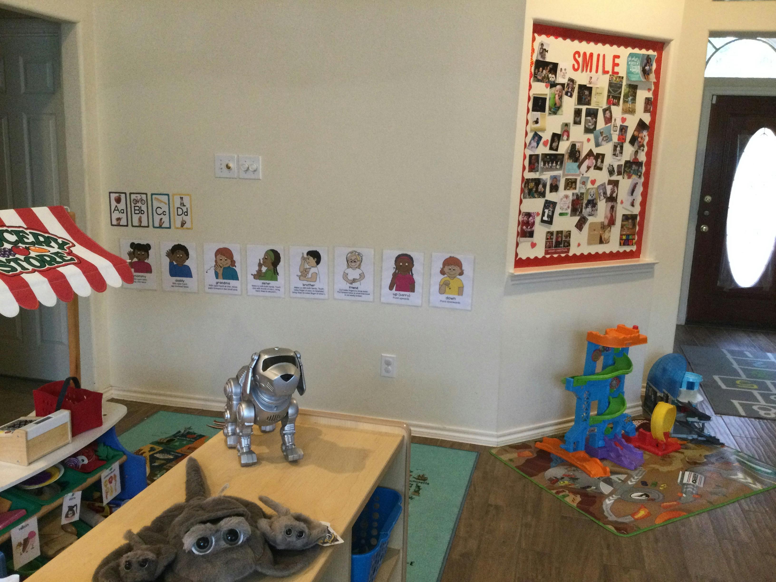 Playroom with toys, a bulletin board, and character cards on the wall