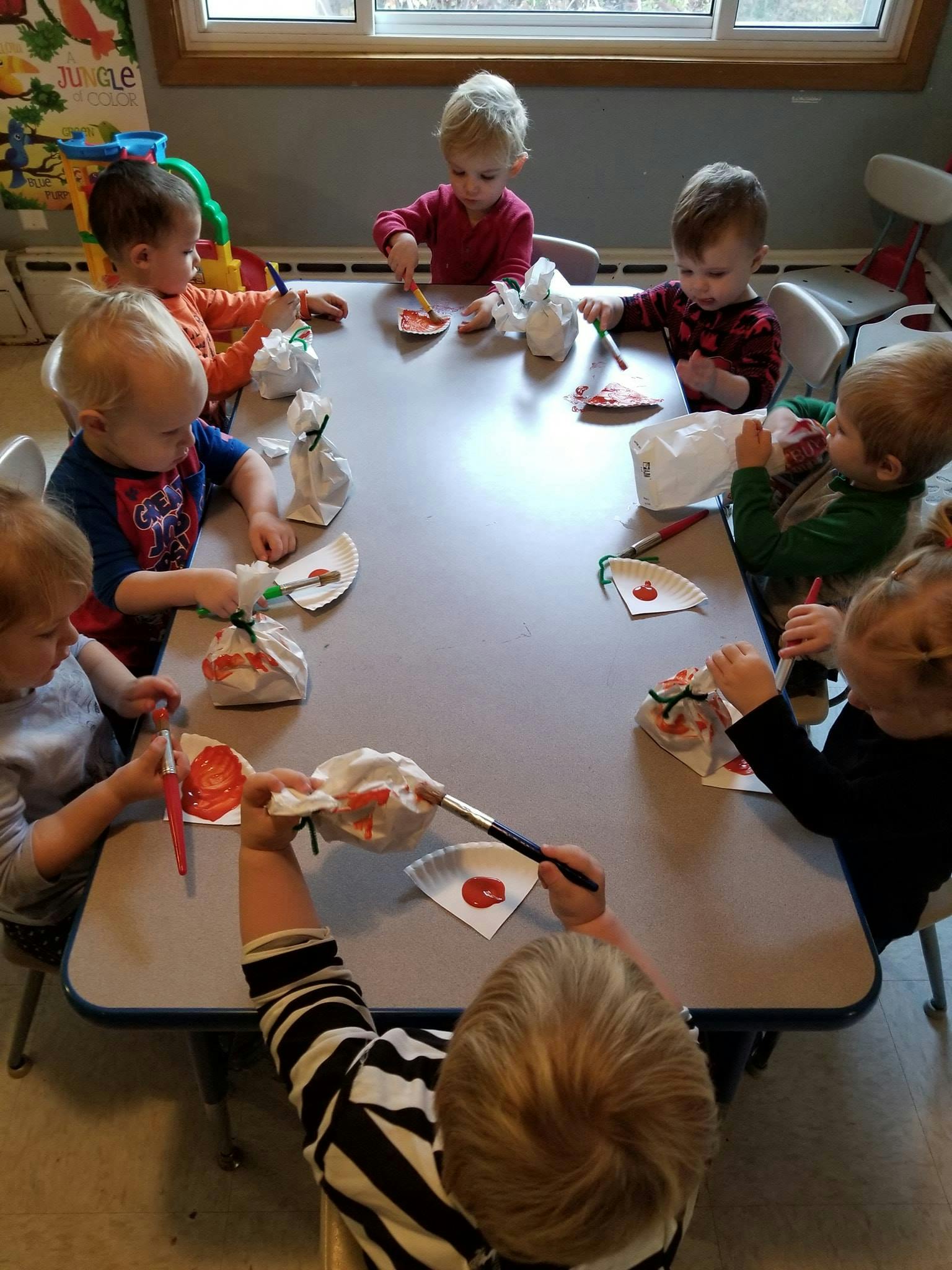 Children painting at a table