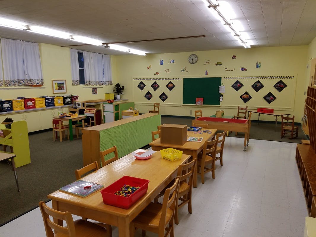 Empty classroom with small tables and chairs