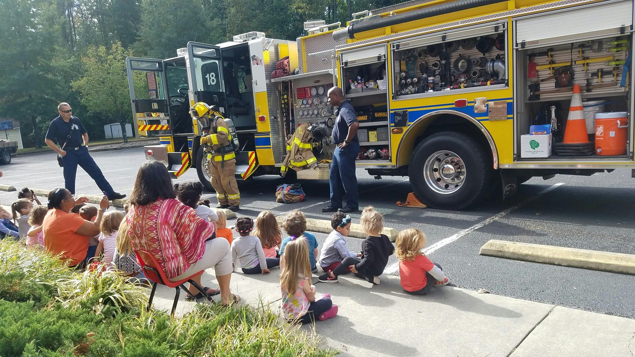 People and children gathered around a fire truck