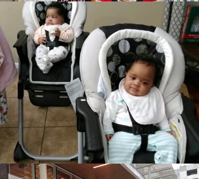 Two babies sitting in high chairs