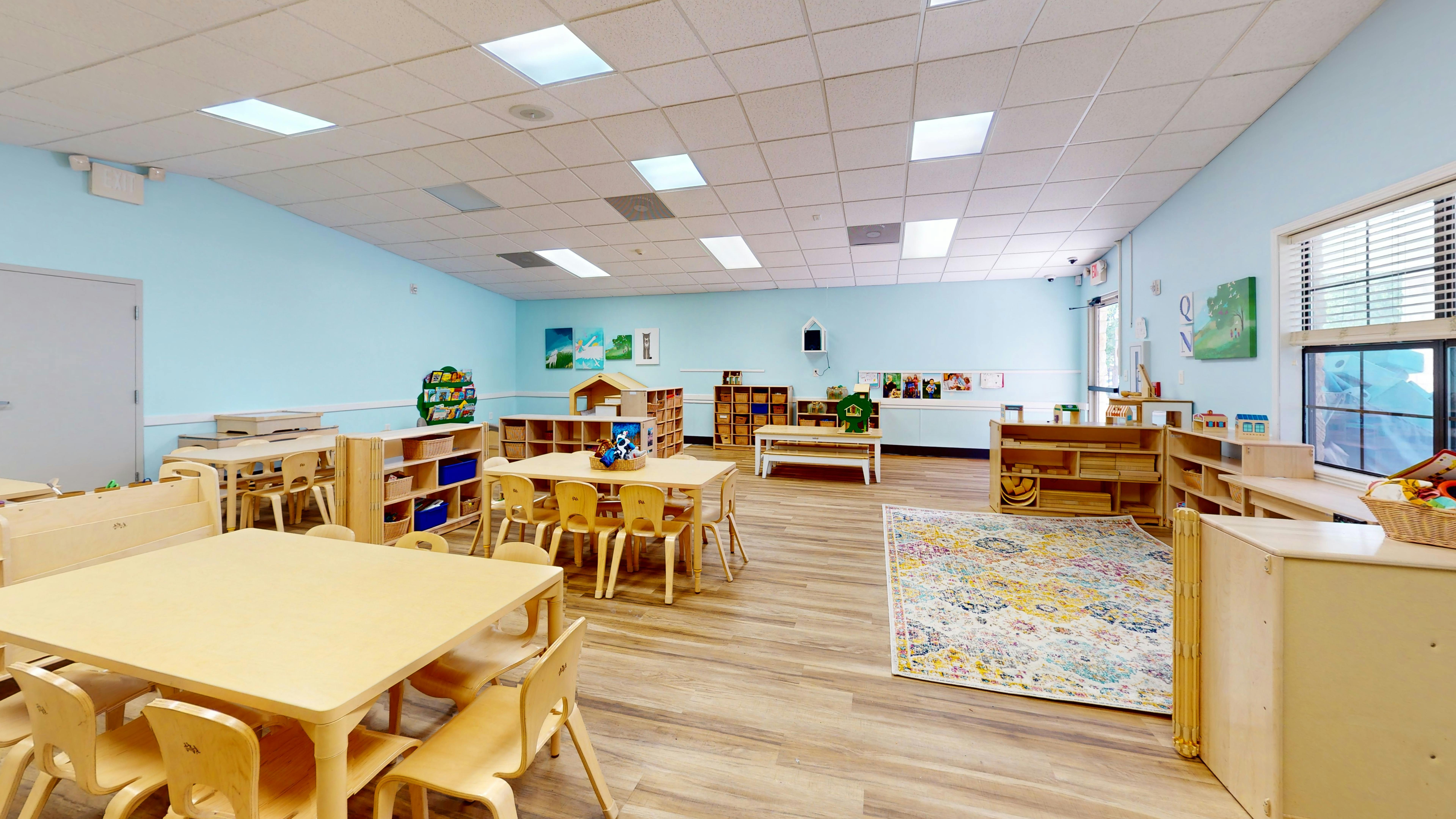 Empty classroom with small tables and chairs