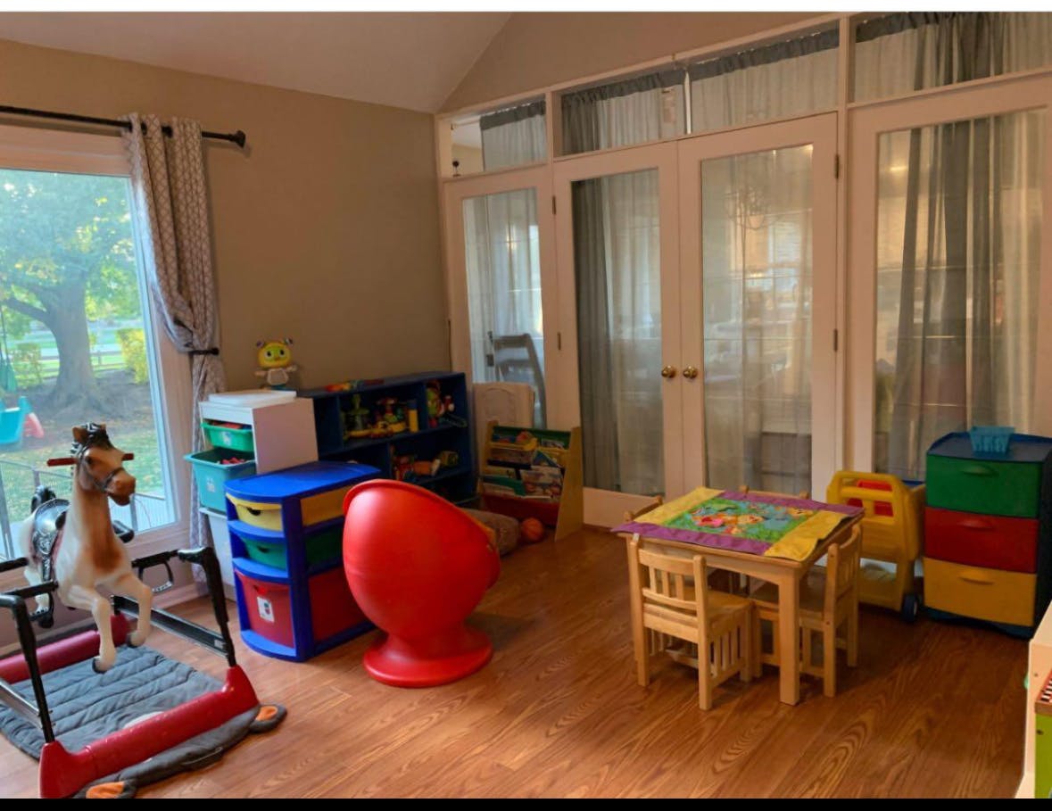 Playroom with a small table and chairs, toy storage, and a rocking horse